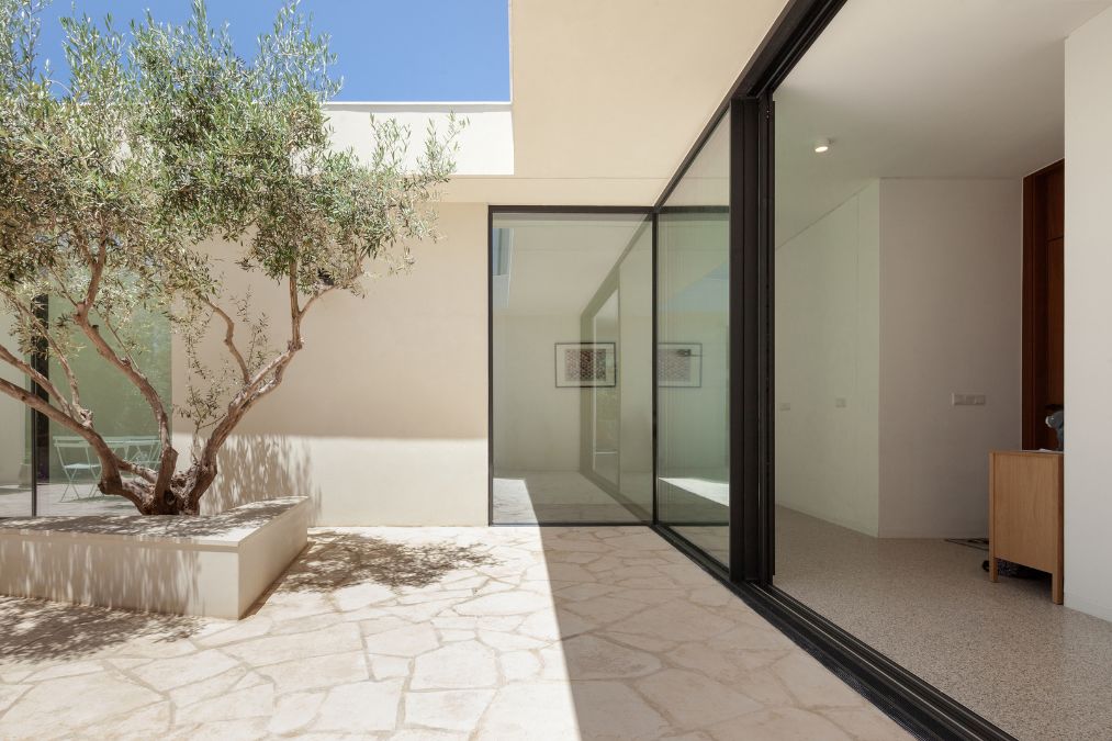 This exterior photograph showcases the harmonious integration of the indoor and outdoor areas of the residence.