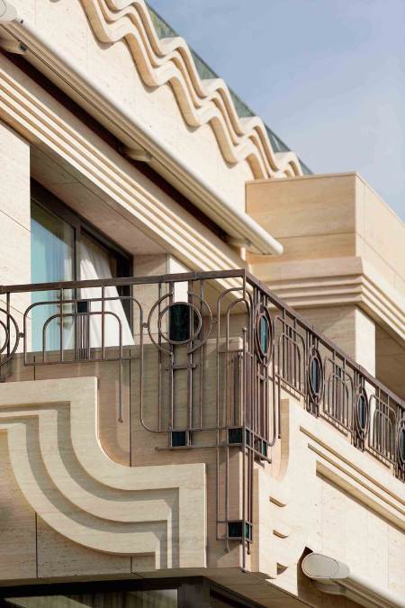 This detailed shot captures the corner section of the deck, highlighting the intricate stone carvings and wavy design that are mounted on certain sections of the wall.