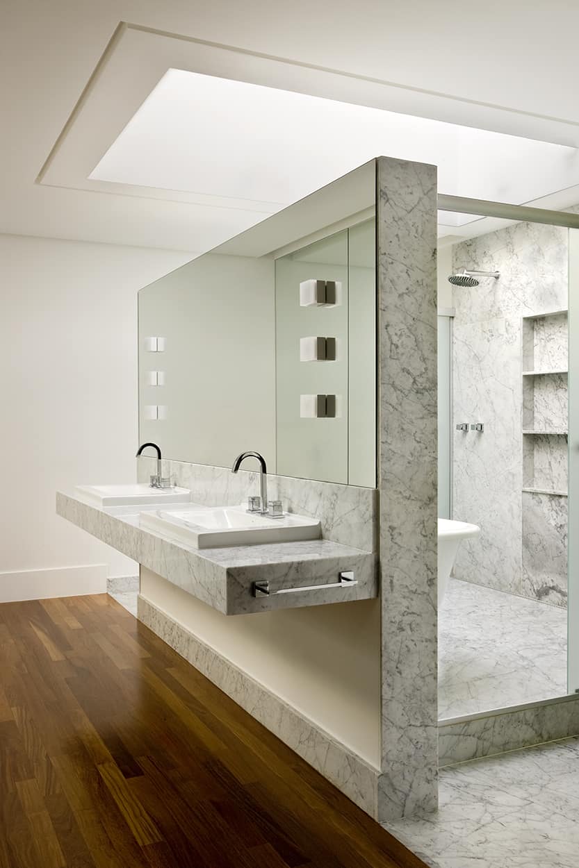 The primary bathroom features a wet room with a deep soaking tub and attached sinks.