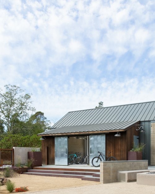 The bike barn is meant to imply an additive construction over time to the guest house.