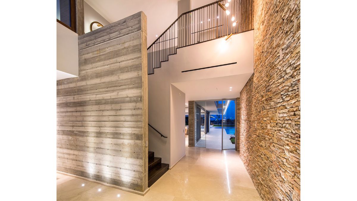 Bricks, cement, and a white ceiling and flooring make up the inside.