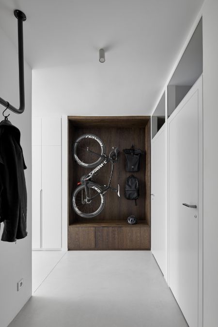 This is an interior shot of a pure white walk-in storage and cabinets, which includes a section designed for bike storage. 