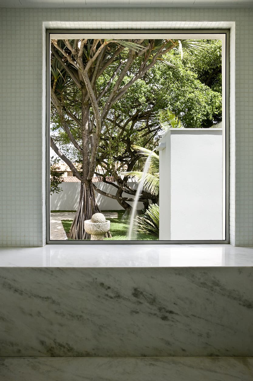 A picture window in this bathroom frames the serene garden.