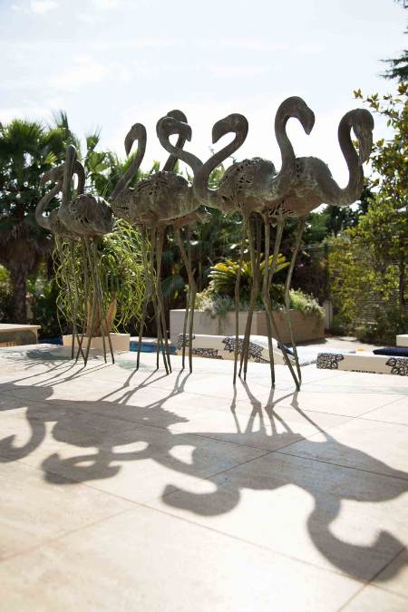 A sculpture of peacocks displayed outdoor. 