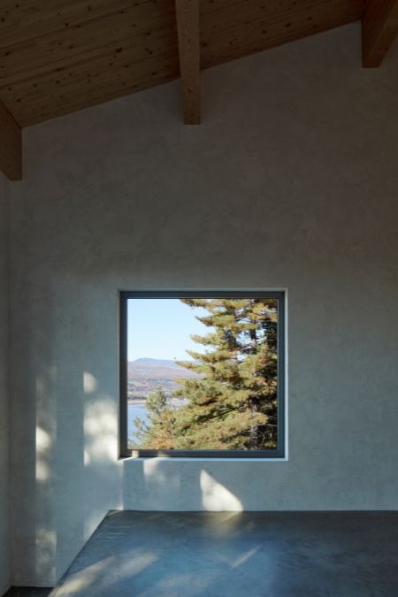 A room is featured with a close-up shot emphasizing its sizable window, providing a picturesque outside view.