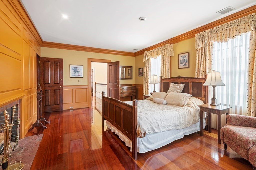 The bedroom features polished tile flooring, a wooden bed, and a fireplace that keeps the room warm.