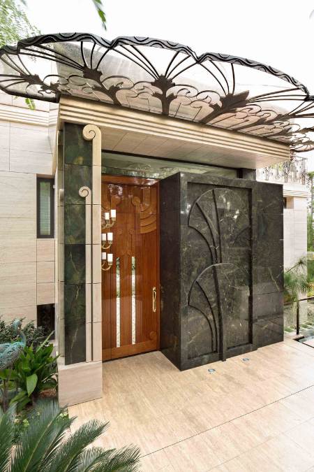 The entrance door features a distinct design that prominently displays a black, solid marble material.