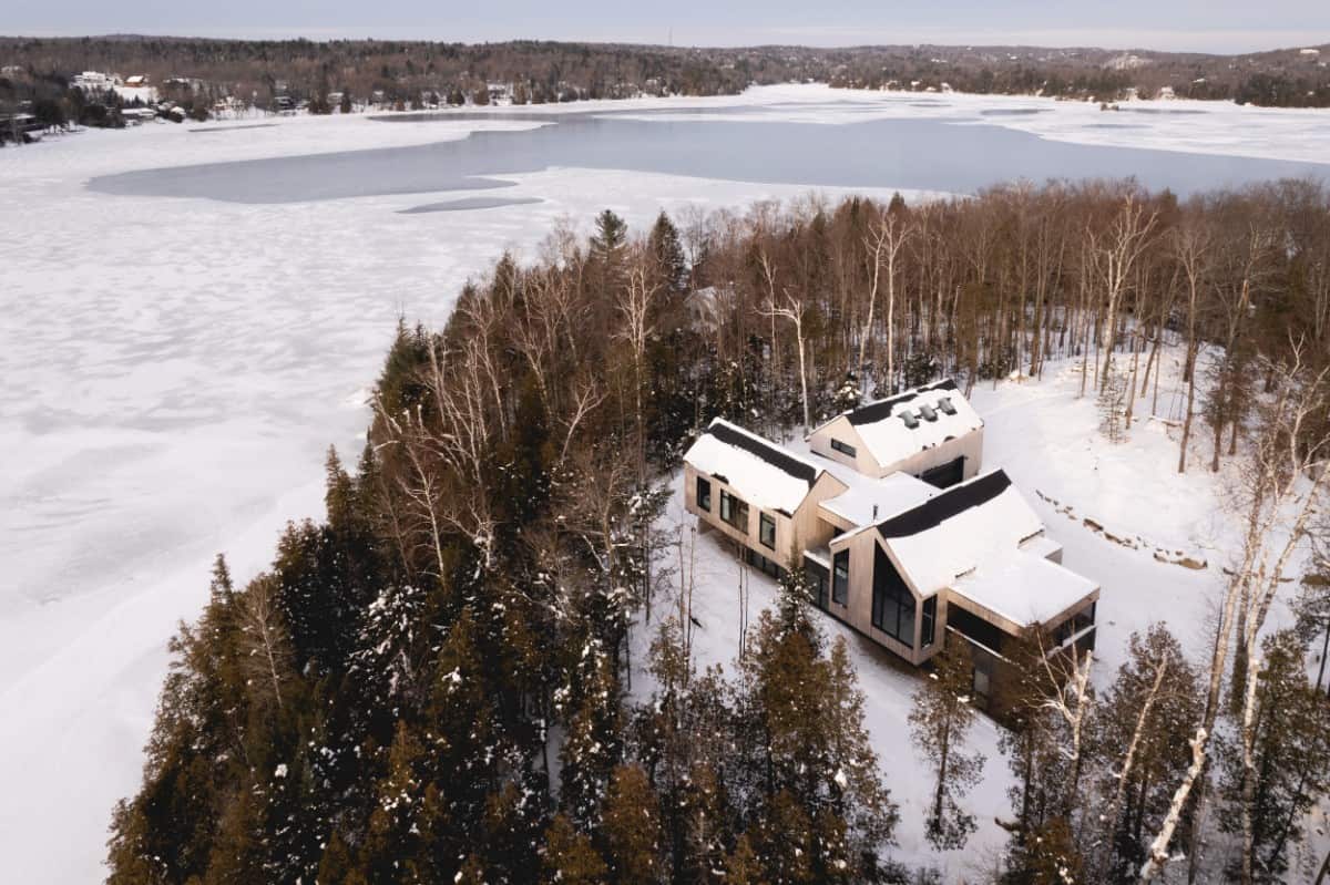 An aerial view of the house surrounded by soaring trees.