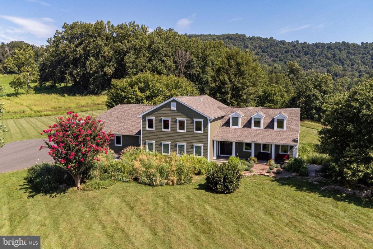 The exterior of the house features wooden siding and asphalt shingle roofing giving off a luxurious look.