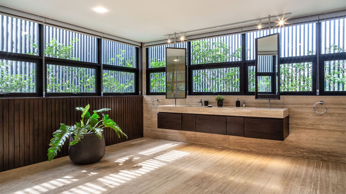 The image offers a unique perspective on the bathroom, providing an intimate glimpse into the exquisite design of the space, with a particular focus on its two-station basin sink.