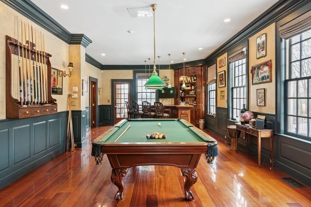 A billiard table near that home bar is perfect for recreation.