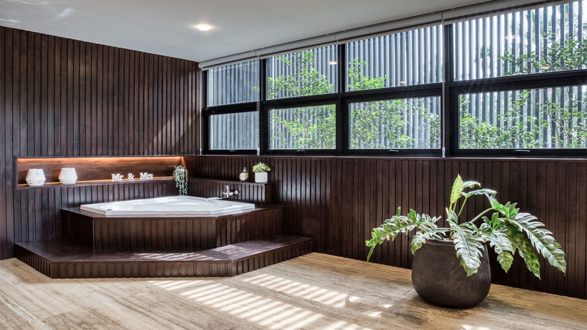 This photograph captures a portion of the bathroom, with a particular focus on the elegantly designed bathtub, providing an intimate glimpse into the exquisite design of the space.