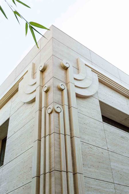 A high angle view that focuses on the corner of a wall with intricate stone carvings.