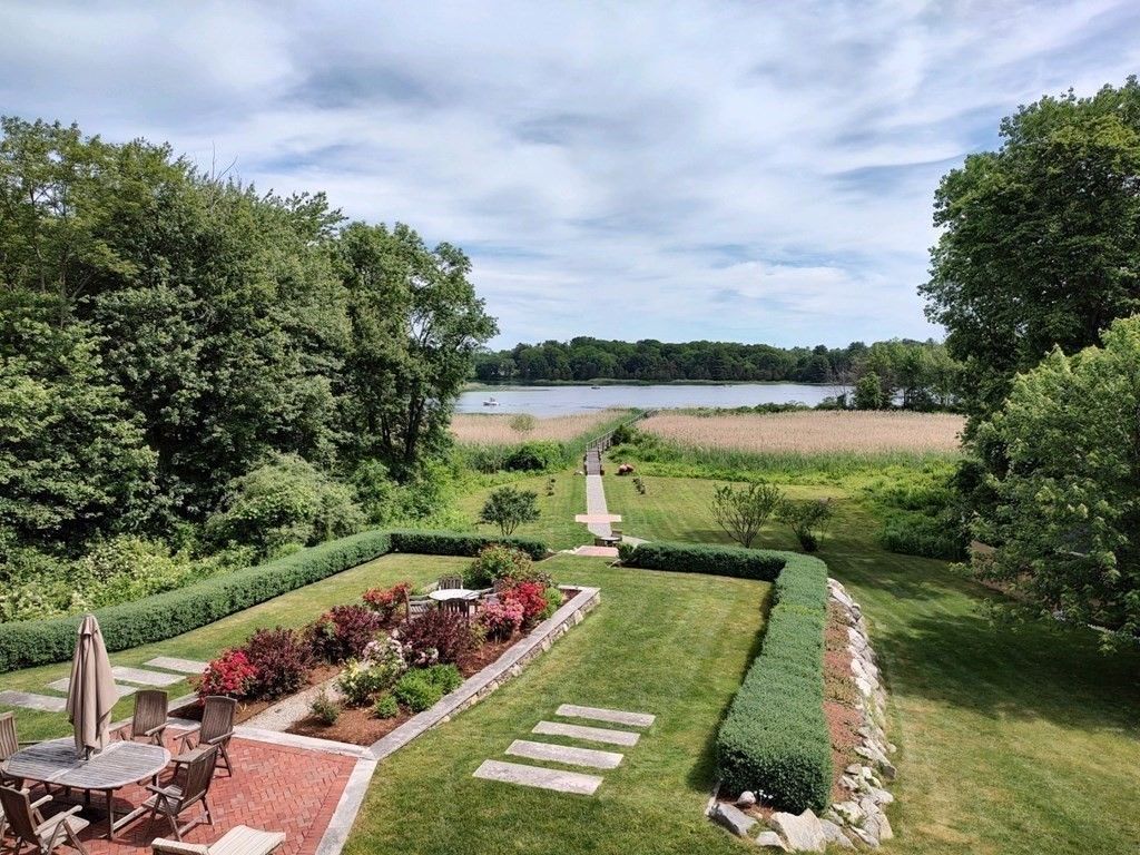 The backyard features a beautiful garden and has a view of the river.