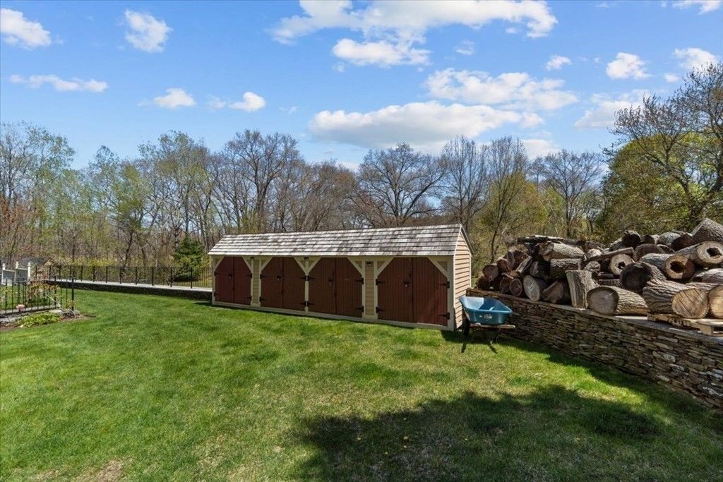 The storehouse features unchopped firewood used for the fireplace.