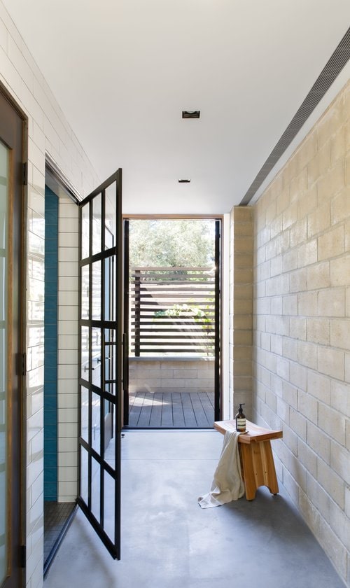 In the main house, by locating operable walls on either of the long sides, as well as having operable doors and garage door on the short ends, this allows for continual cross ventilation in both directions which helps keep the house cool.