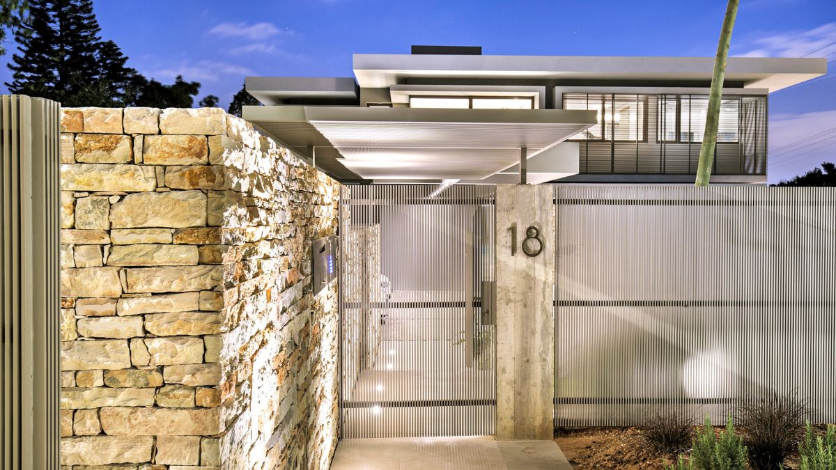 Cement, steel, bricks, and a light grey and white color scheme make up the exterior.