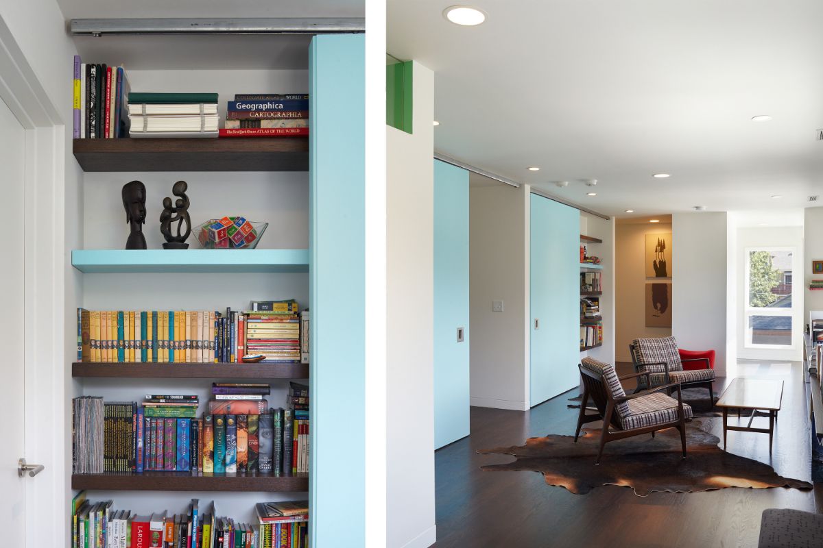 A bright reading room with open powder-blue book shelves brimming with volumes.