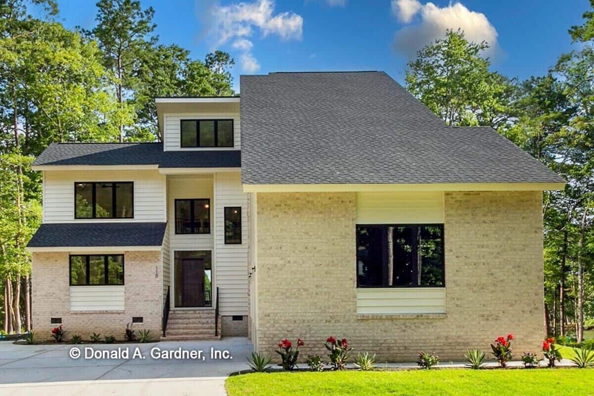 Front exterior view showcasing the home's main entrance and courtyard-entry garage.