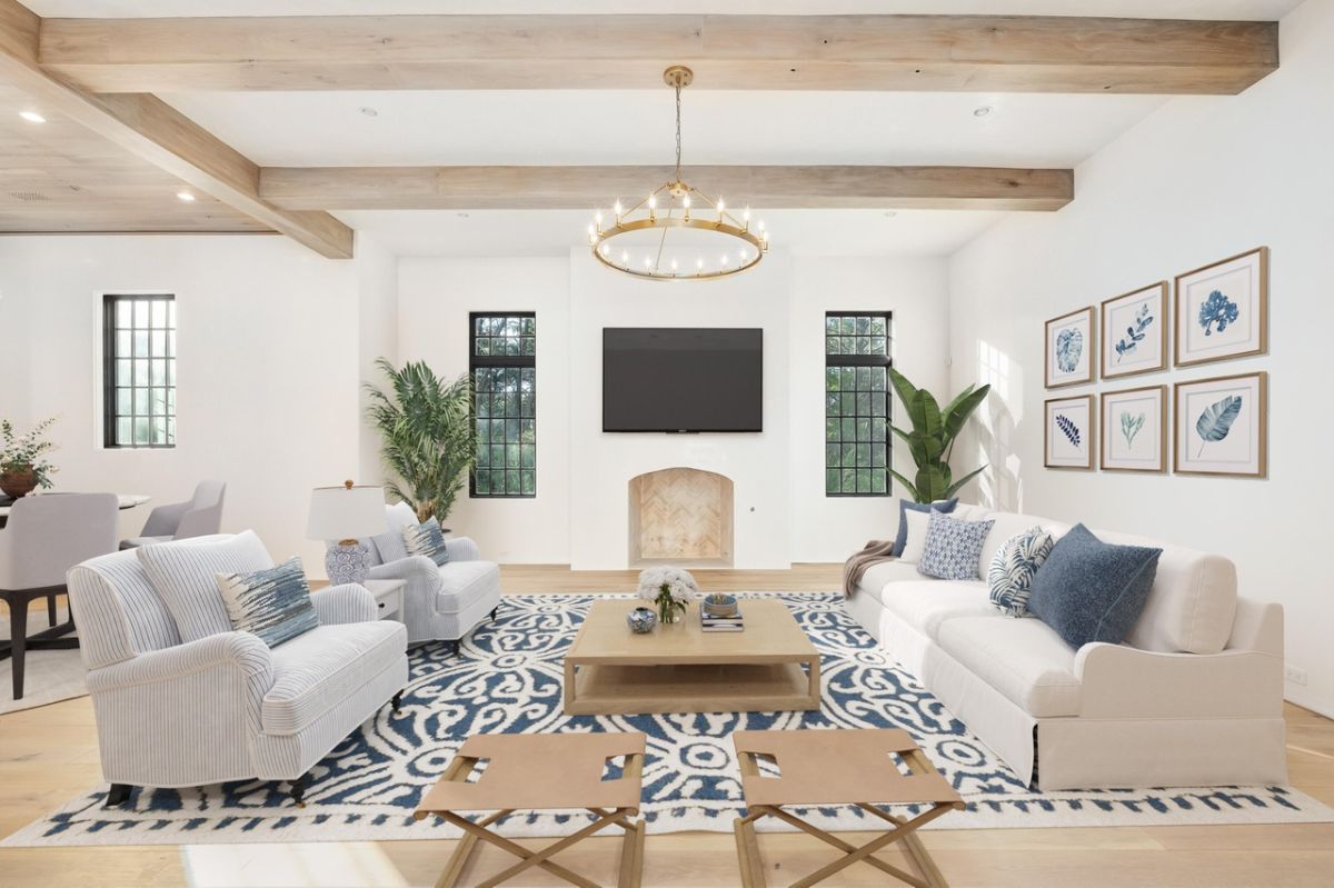 The area reserved for the living room features wooden beams and a fireplace.