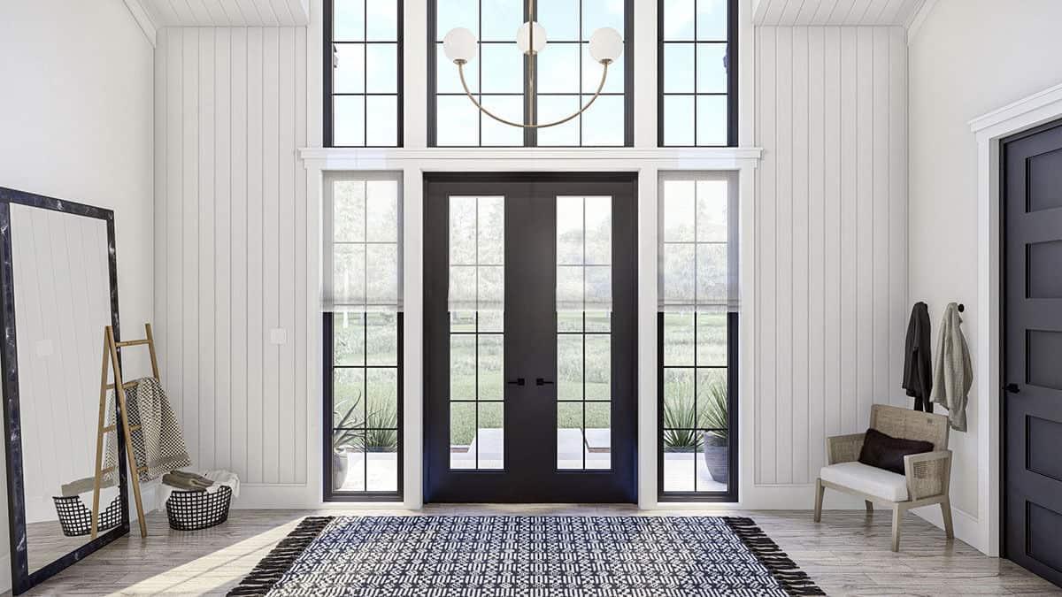 A French front door along with sidelights and transoms bring natural light into the foyer.