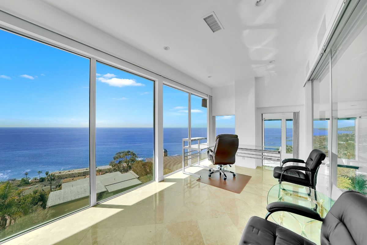 The loft features leather chairs and glass walls that showcase the horizon.