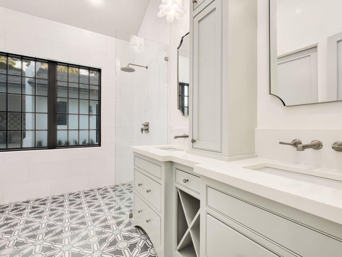 The bathroom features tile flooring and a vanity with a tile countertop.