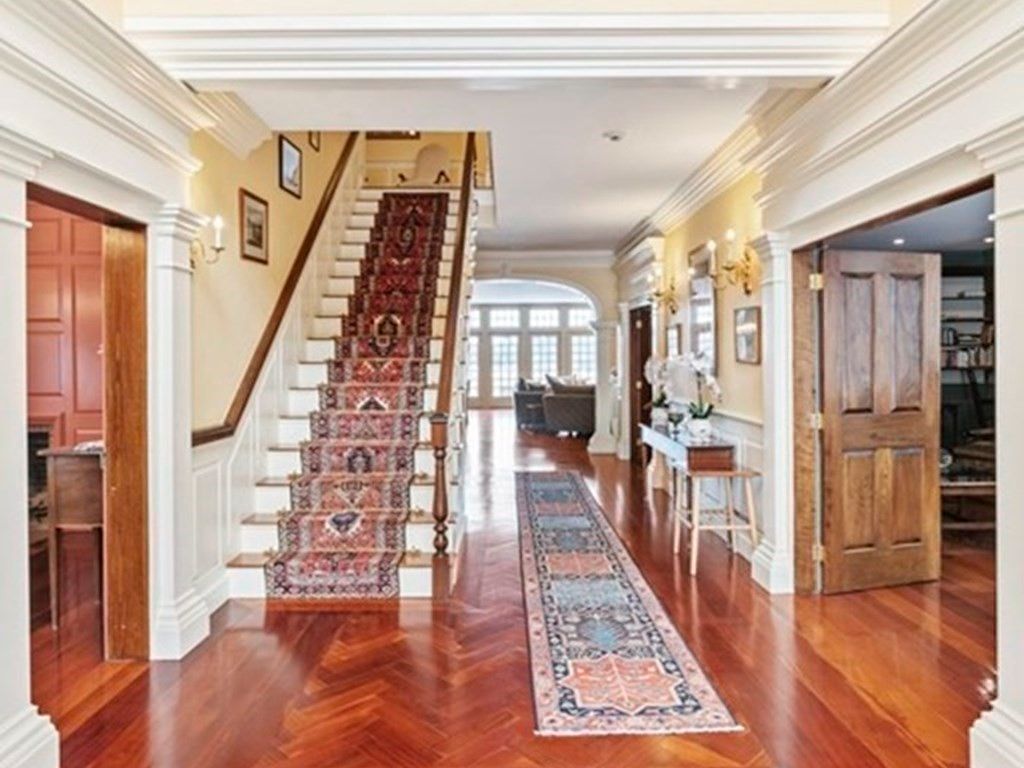 The house features a wooden staircase with stair runners that gives a luxurious feel.