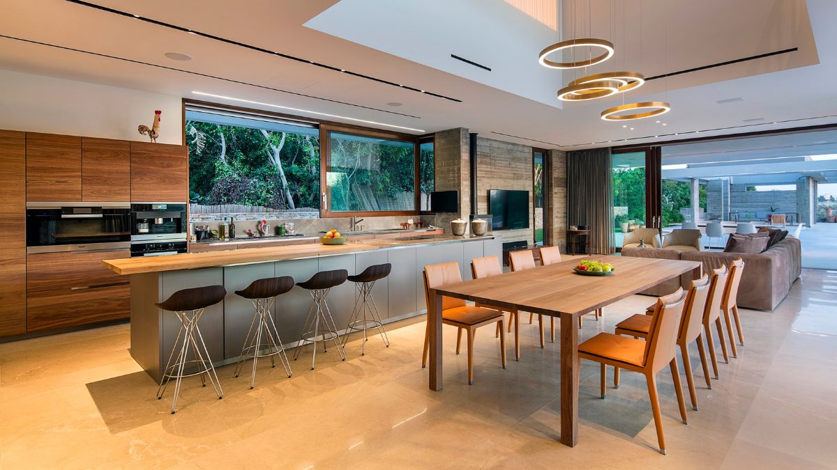 The dining area and kitchen's wooden structures work well together in a symphony of built form brought together by light.