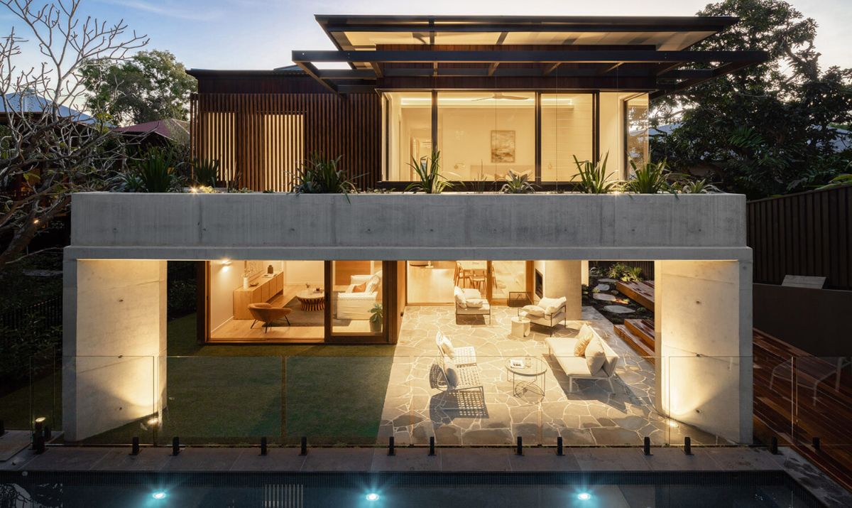 Terraced planting wraps the pool, framing views from the interior living spaces. 