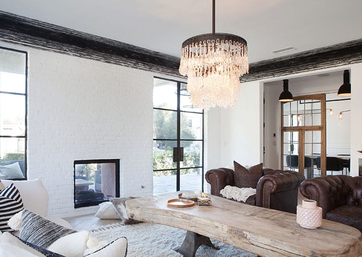 Glazed doors connect the living room with the dining room and outdoor space.