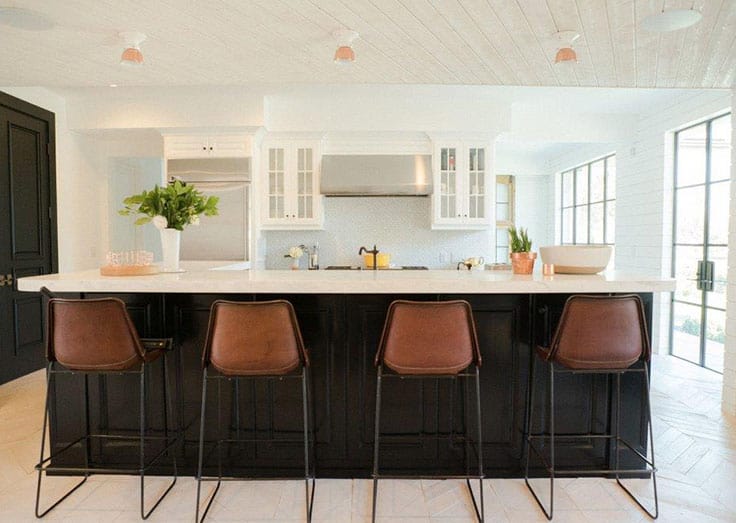 The kitchen features a large island with four bar seating.