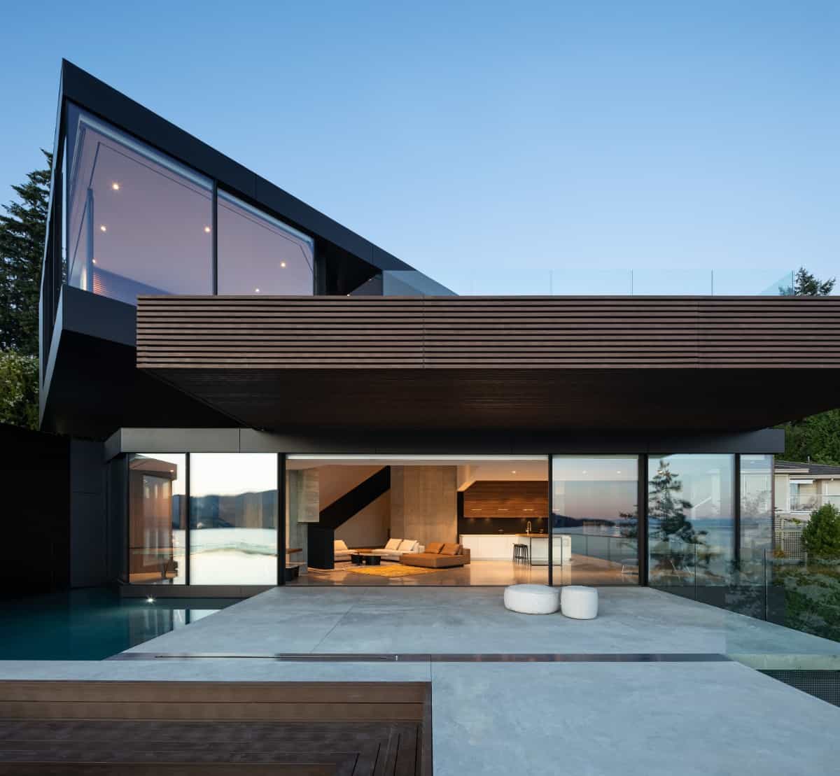 Exterior view of the house showcasing a covered porch and oversized sliding glass doors.