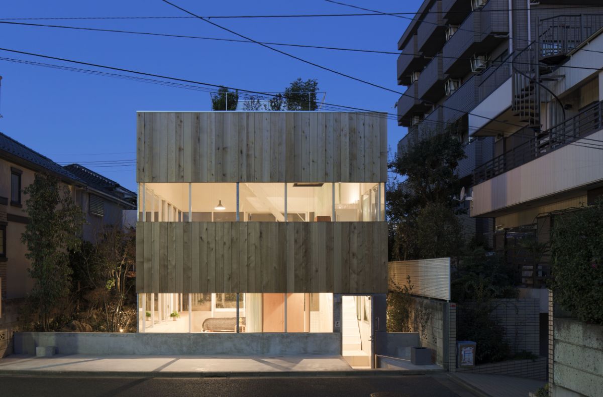 A street view of the house at night highlighting the two glass slits that run the length of the structure.