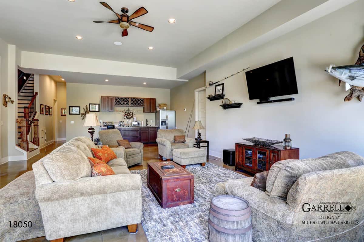 The basement has velvet seats, a wall-mounted TV, and a kitchenette.