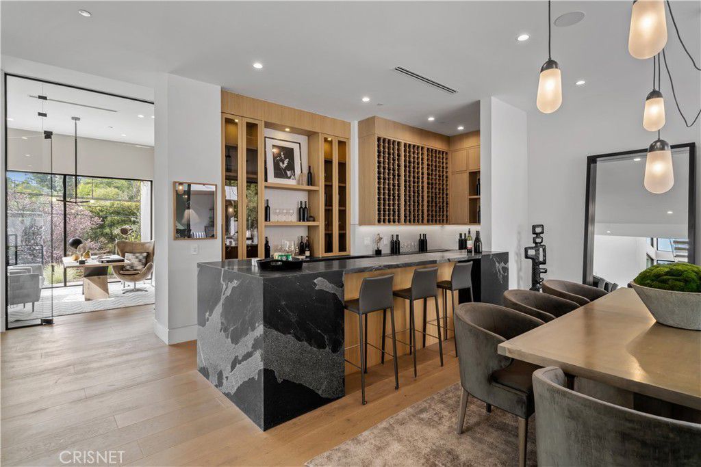 The home bar features a wine cellar and a bar counter, giving a luxurious feel.