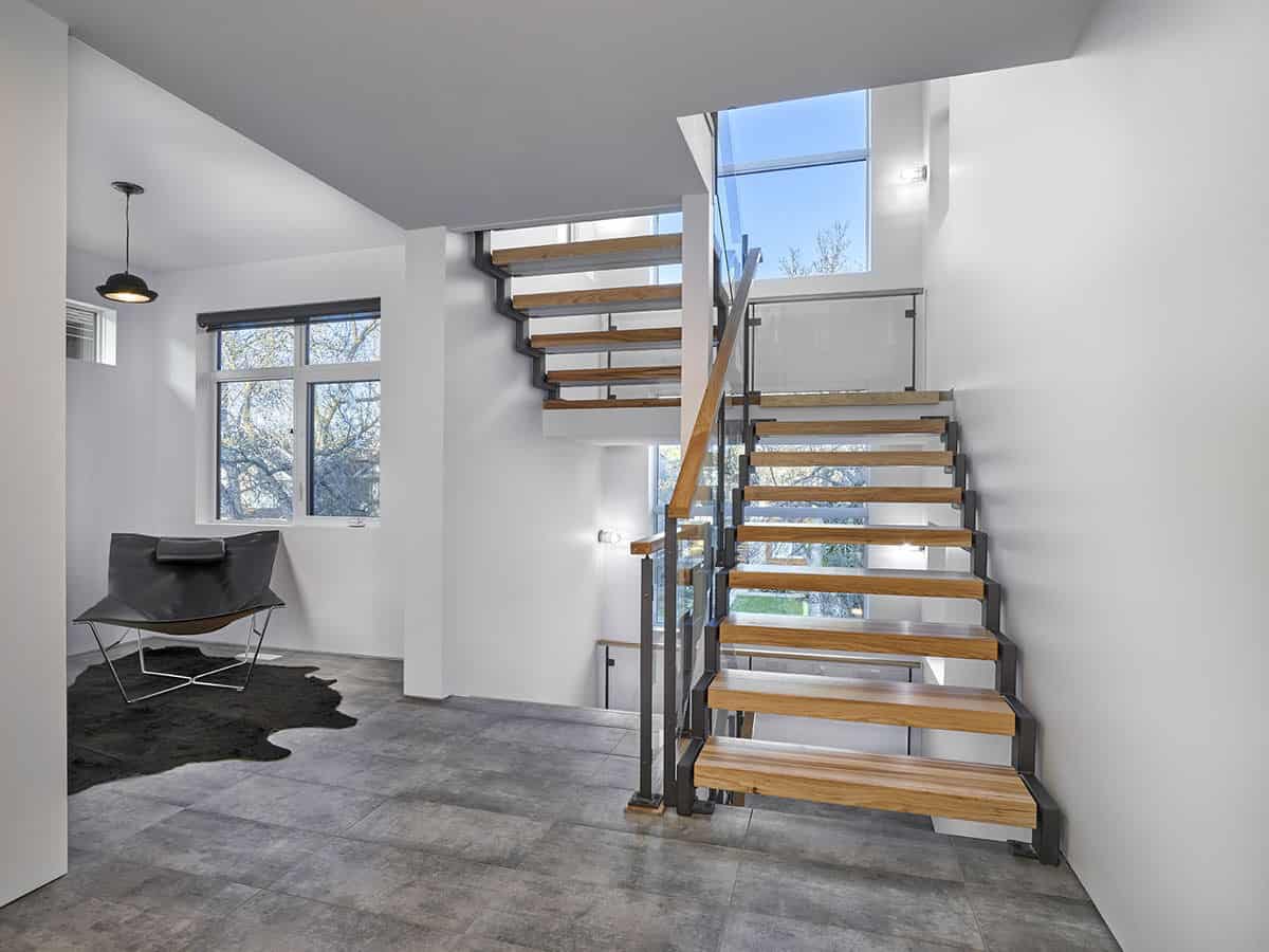 The foyer has concrete tiled flooring and staircases leading to the upstairs bedrooms and down the basement.