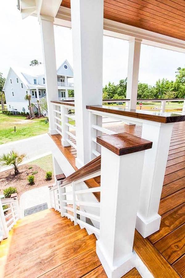 The main level floor plan is accessible via the wooden staircase on the side of the home.