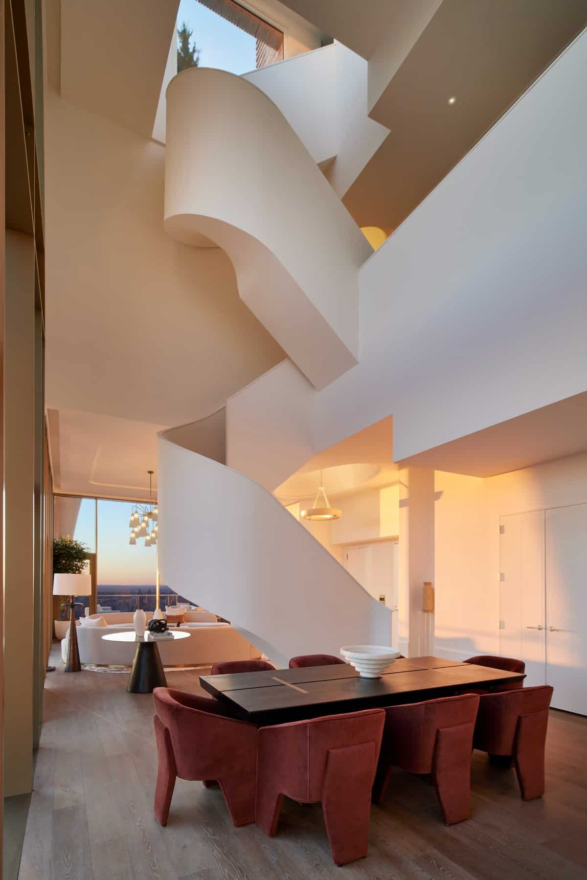 The living room and dining area are separated by a stunning spiral staircase that connects three levels with 13' ceilings.