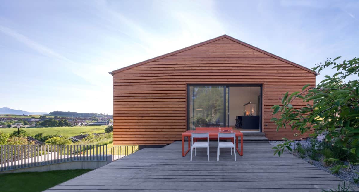 The upper-level deck connects with the home's living space through sliding glass doors.