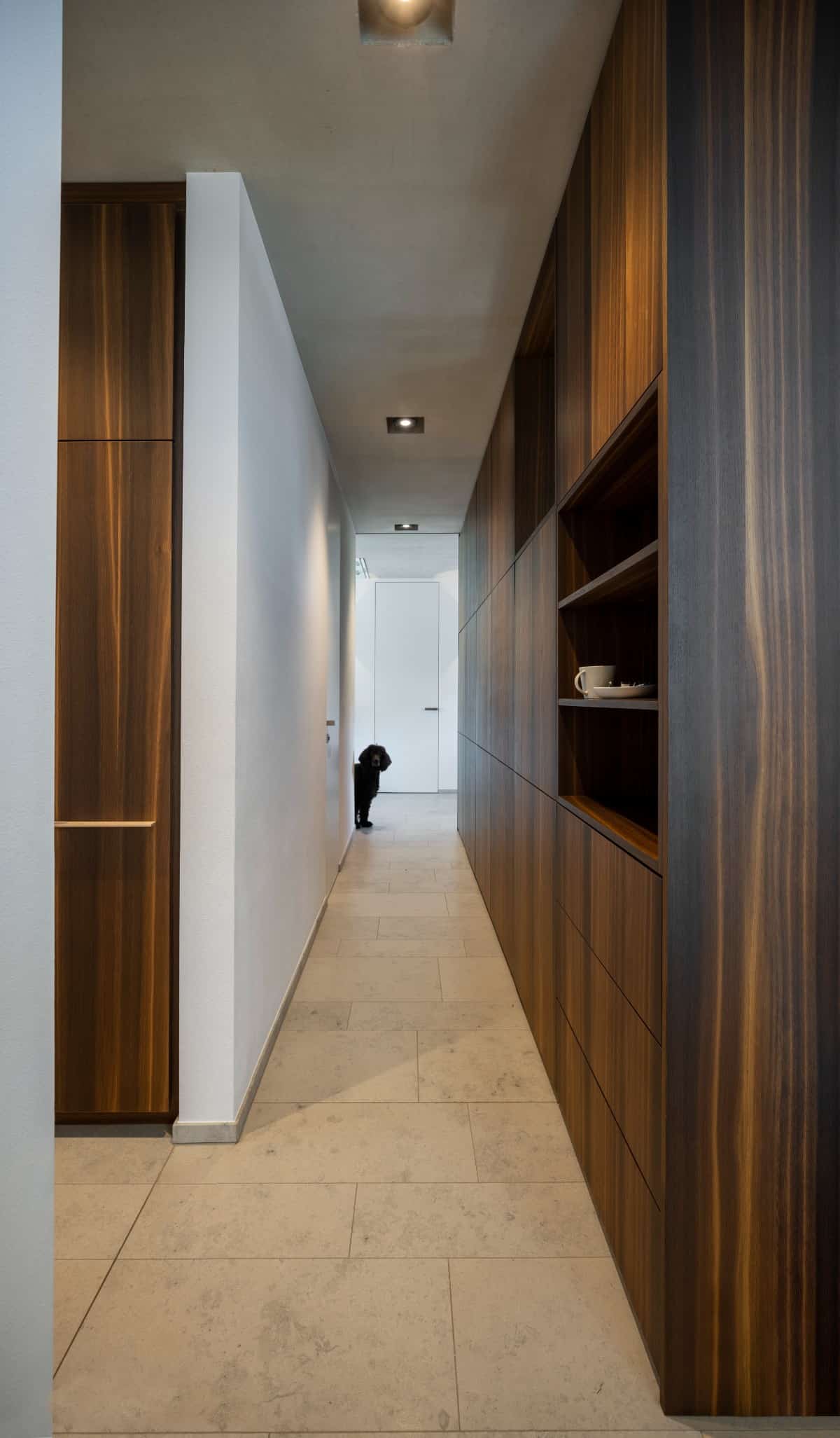 The oak wood elements are echoed on the built-in cabinets.