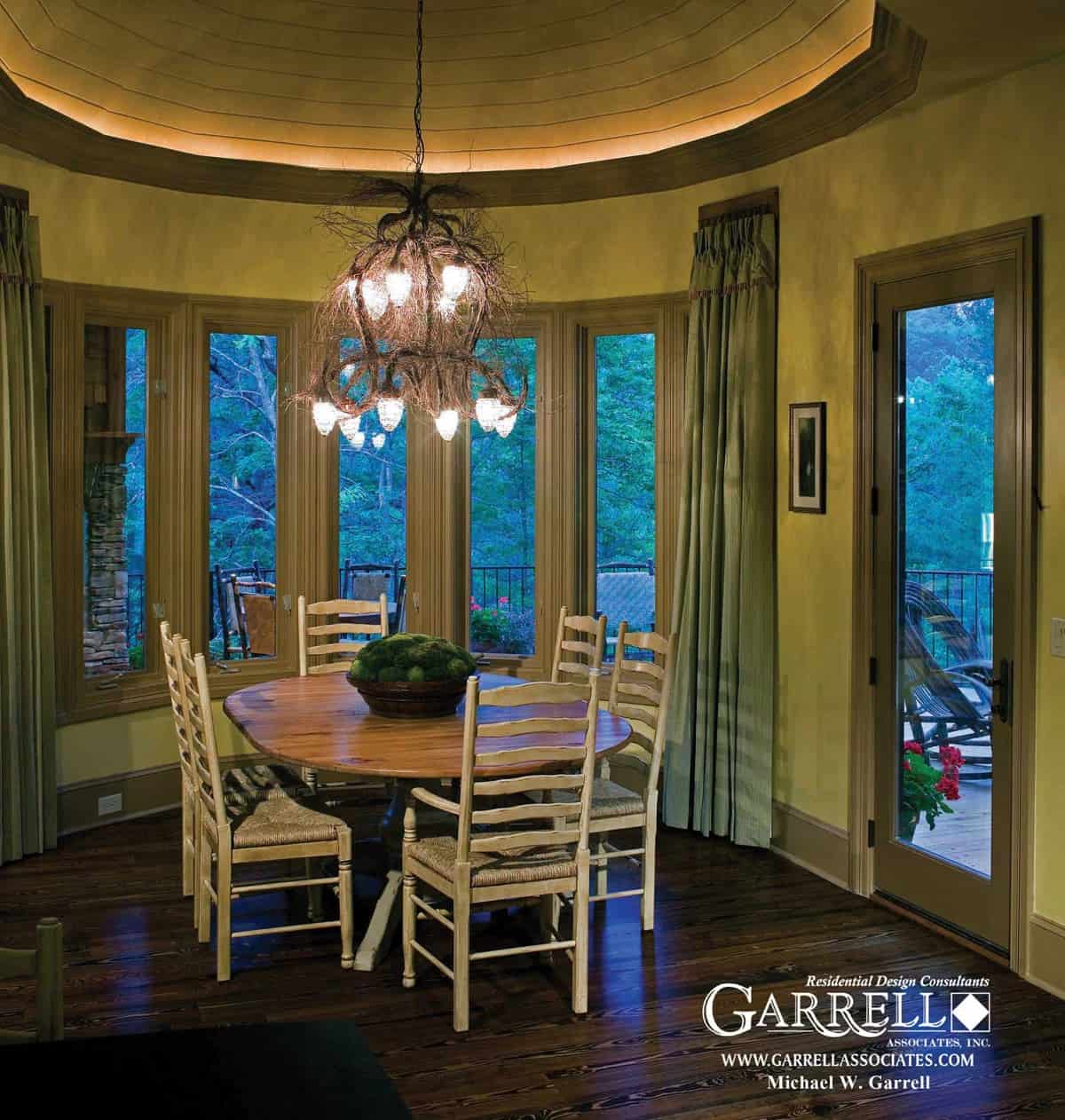 The breakfast nook has a round dining set against a bow window and direct access to the rear deck via a glazed door.