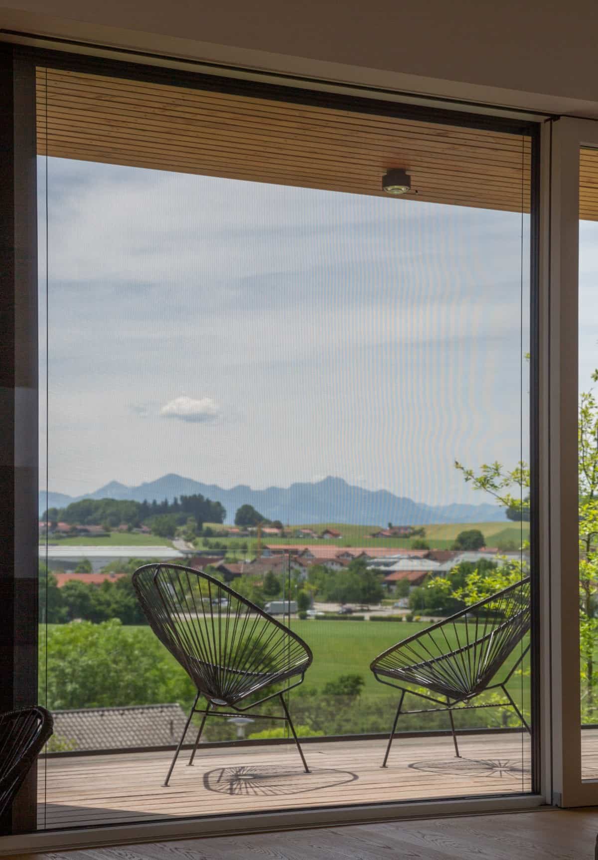 The deck with round-back chairs offers a peaceful spot to relax and unwind.