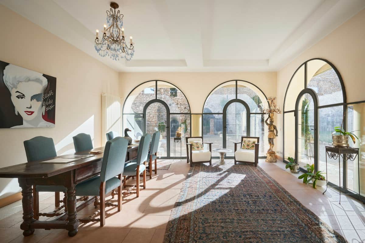 Huge arched windows in the kitchen are mirrored in the formal dining room.