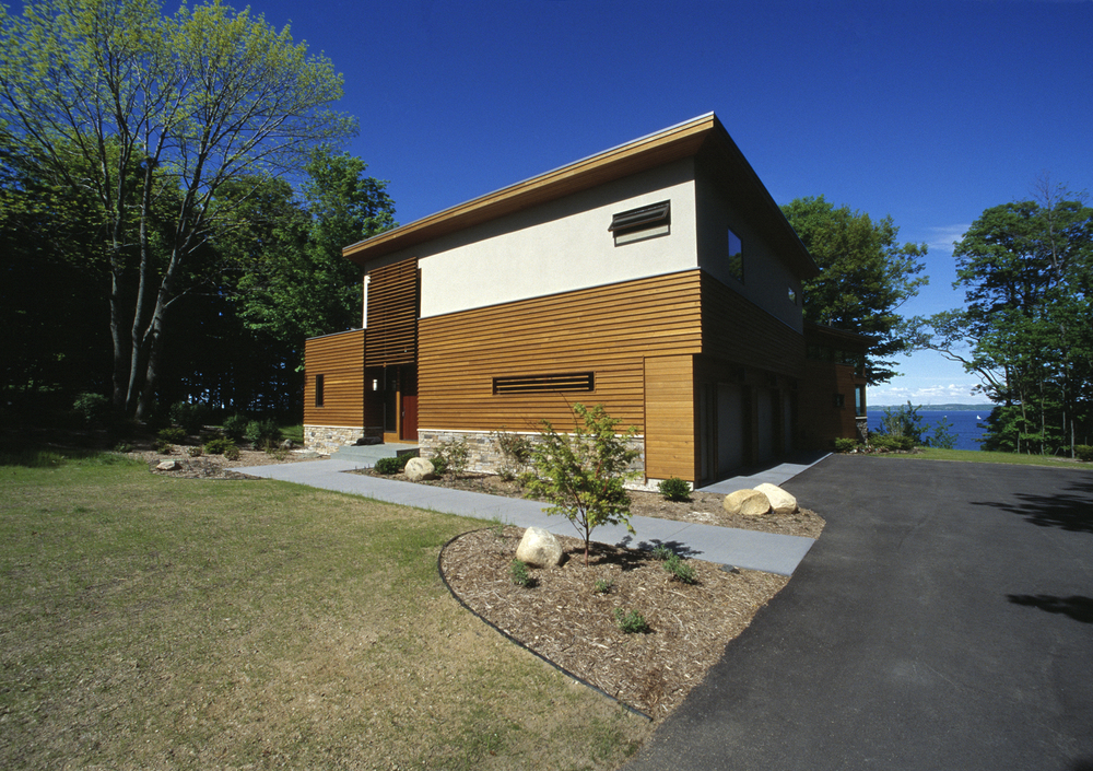 The residence is seen as a choreographed sequence of views, from the approach via a dense grove of trees to an open sunny yard, to movement through the internal spaces. 