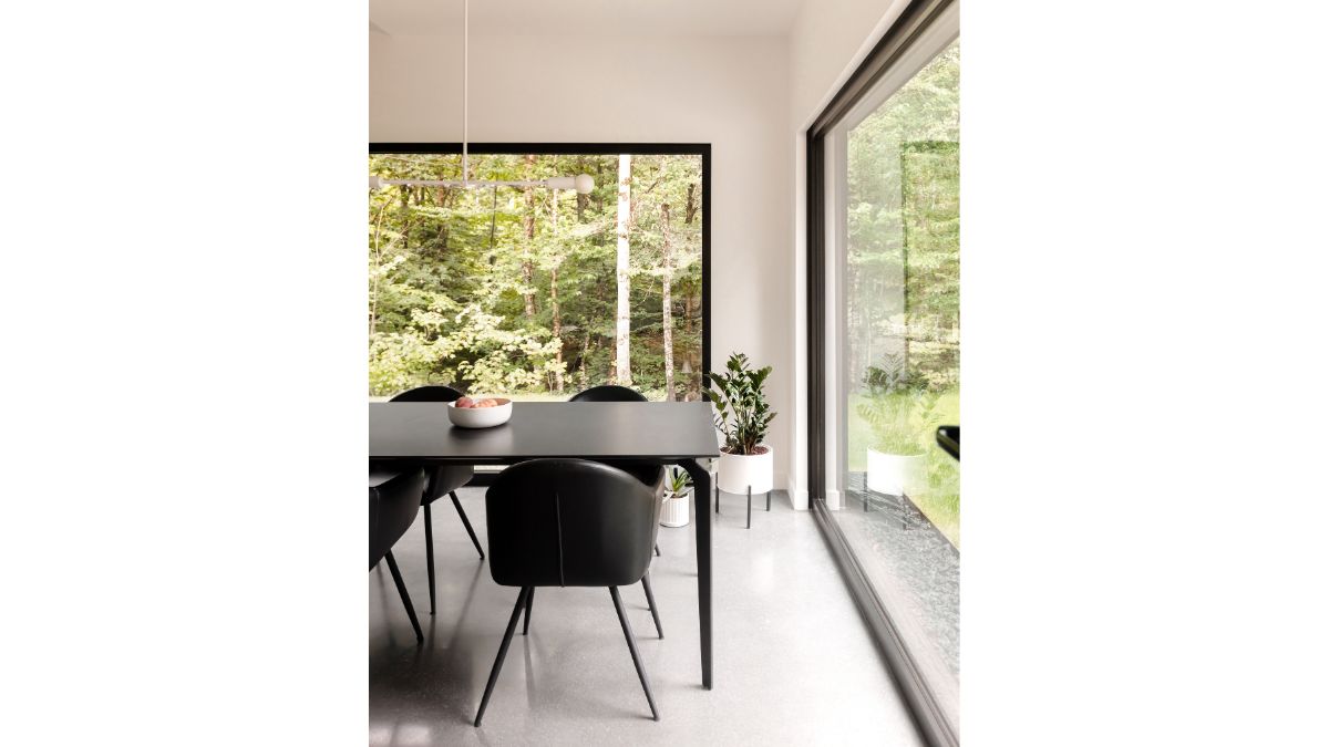 The dining room set's black and white color scheme complements that of the chairs and table.