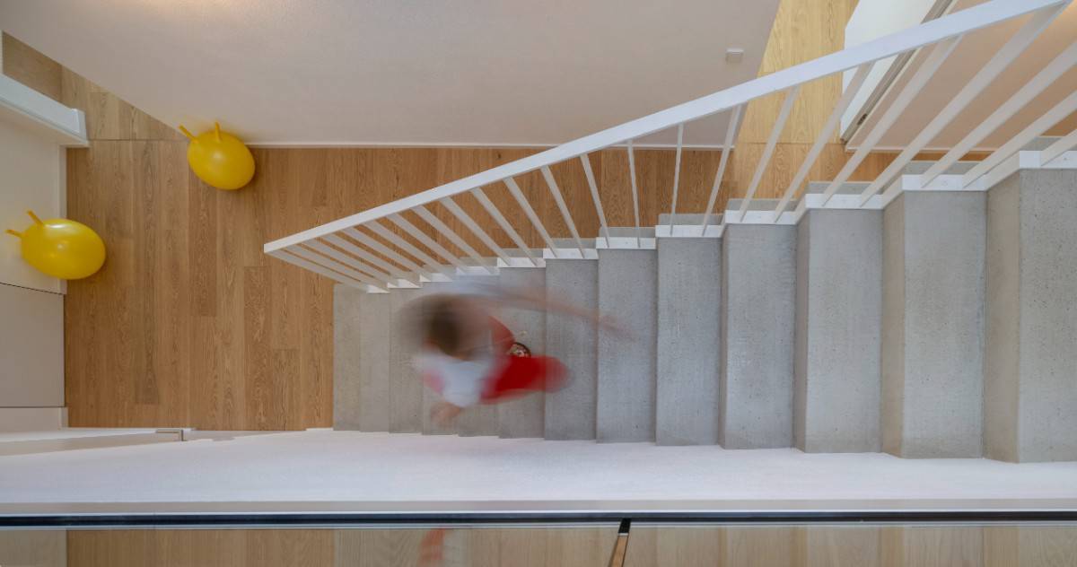 Top view of the concrete staircase against the hardwood floor.