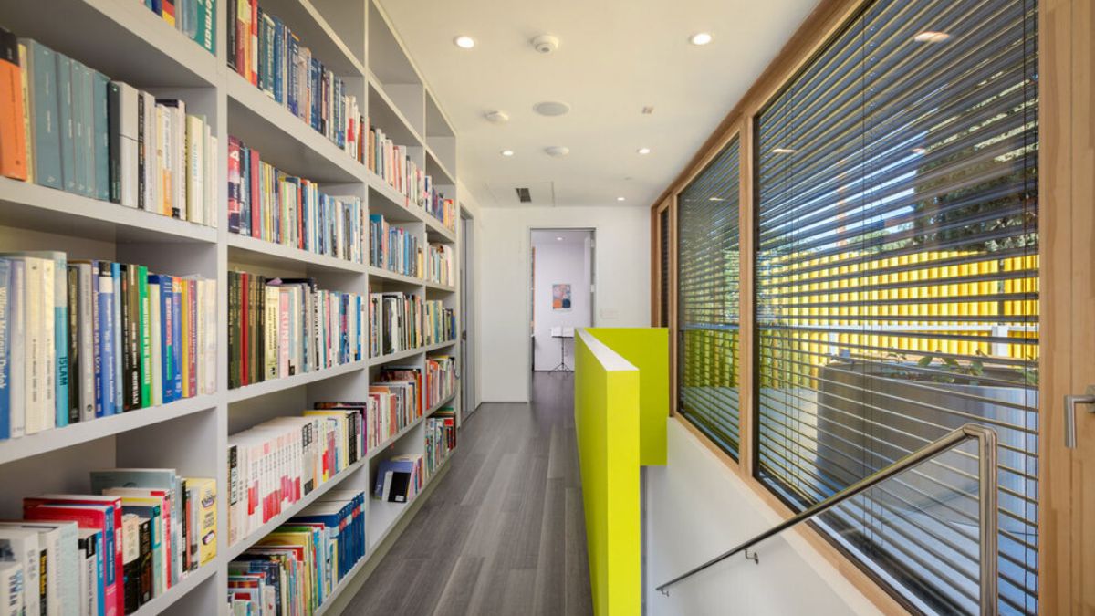 As you ascend, you can see a big cabinet filled with books upstairs.