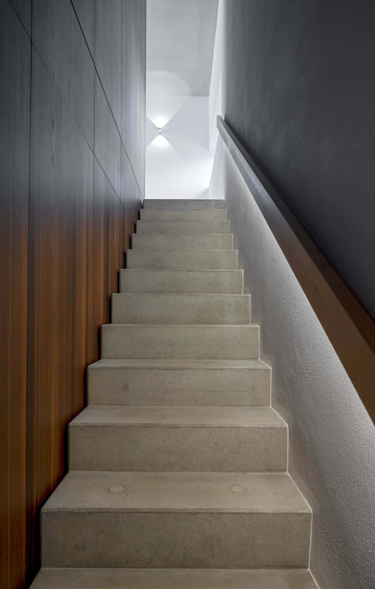 Single-flight staircase with concrete treads and risers.