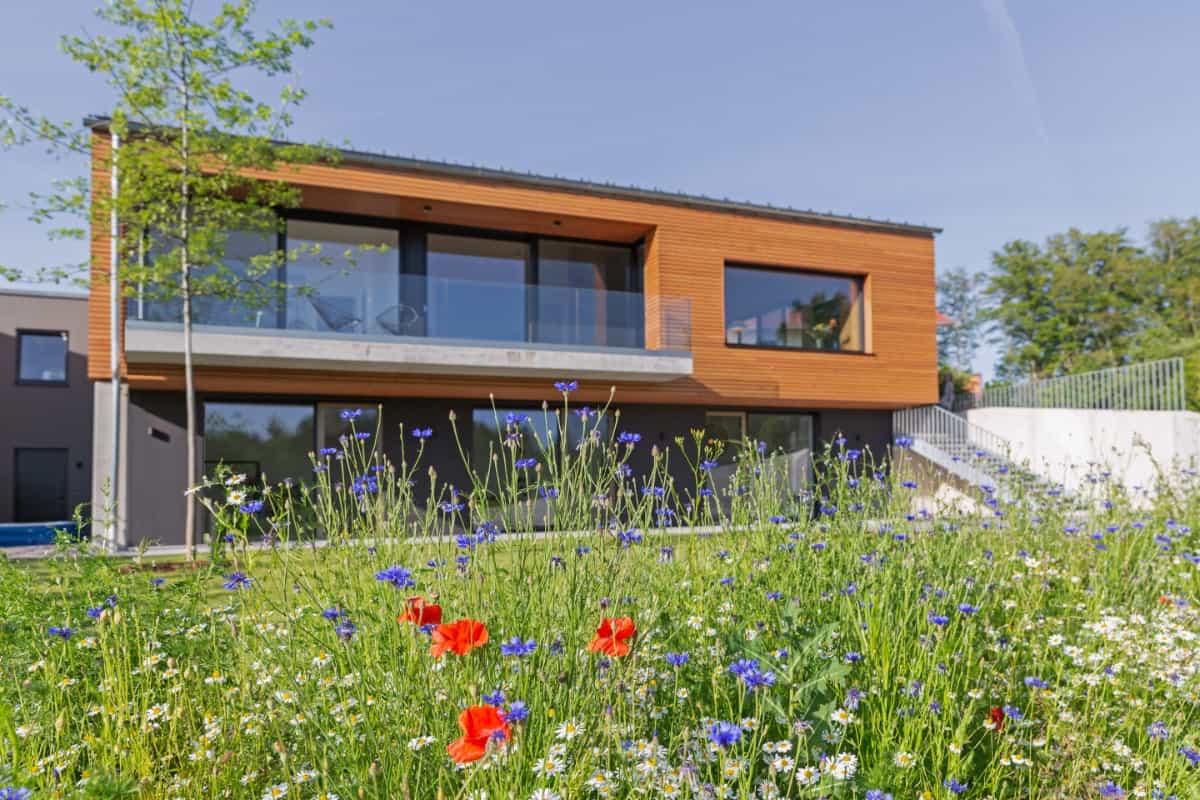 One last look at the home's façade with spacious outdoor living and an external staircase connecting the terrace to the garden.